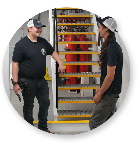 Two Southern Devall employees conversing by a set of yellow stairs