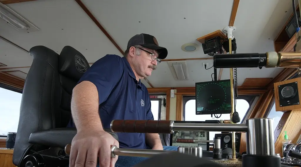 A Southern Devall captain manning his post inside the cockpit of a barge